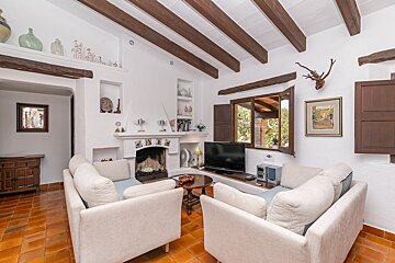 A living room with a fireplace and a flat screen tv