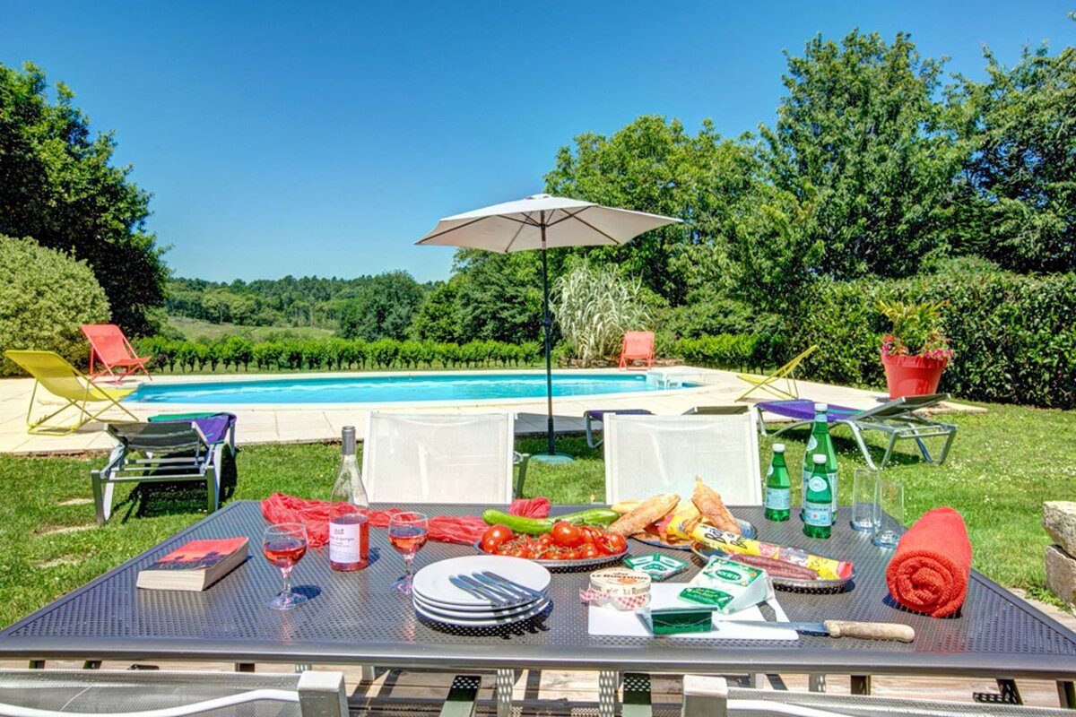 A table with a book and a bottle of perrier on it