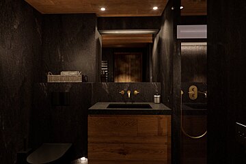 A bathroom with black walls and wooden cabinets