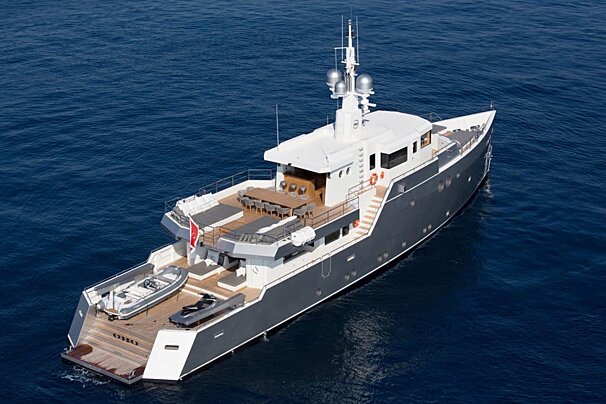 A large yacht is floating in the ocean with a life preserver on the side