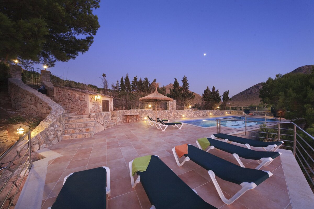 A swimming pool with a gazebo in the background
