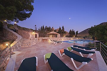 A swimming pool with a gazebo in the background