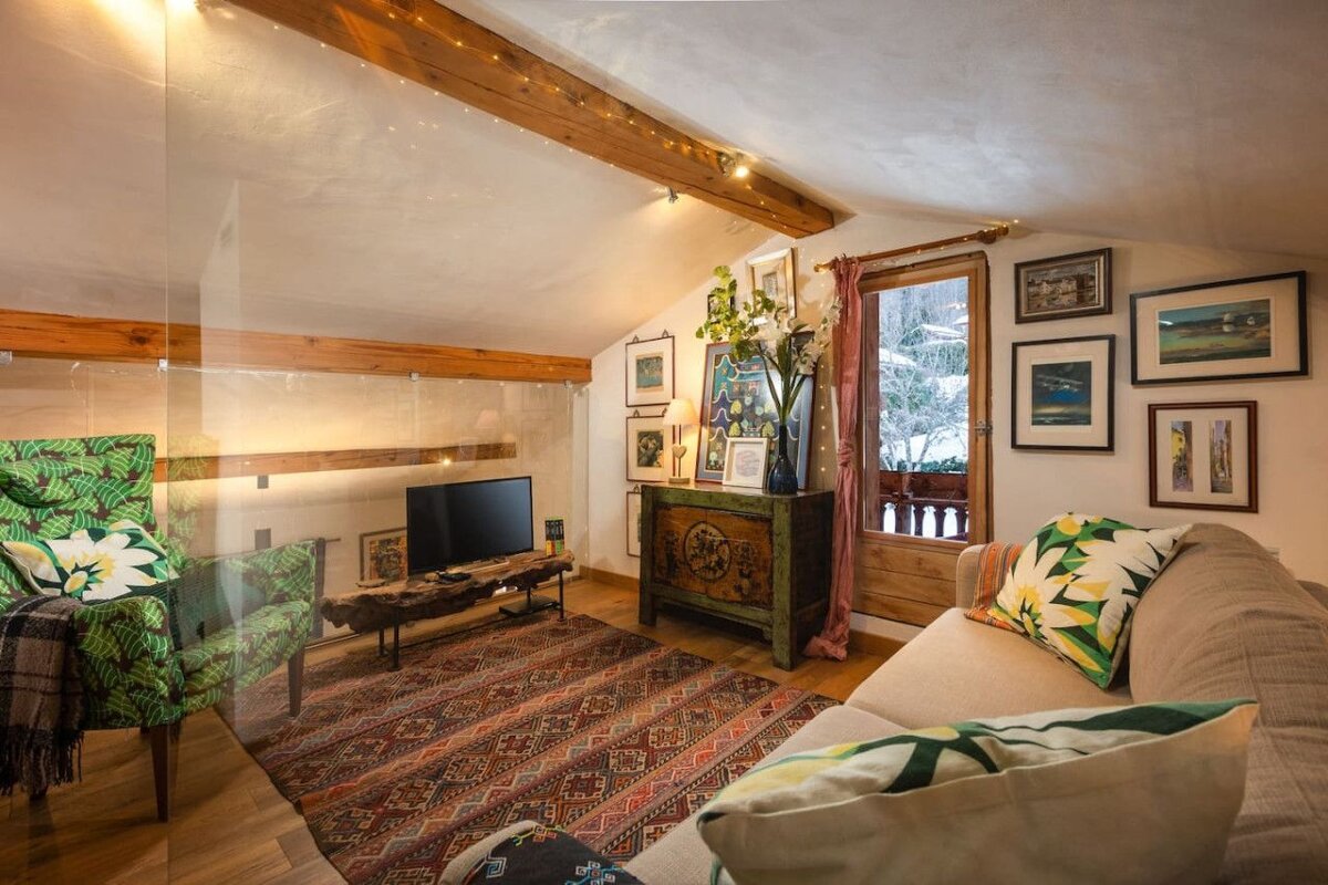 A living room with a couch a chair and a television