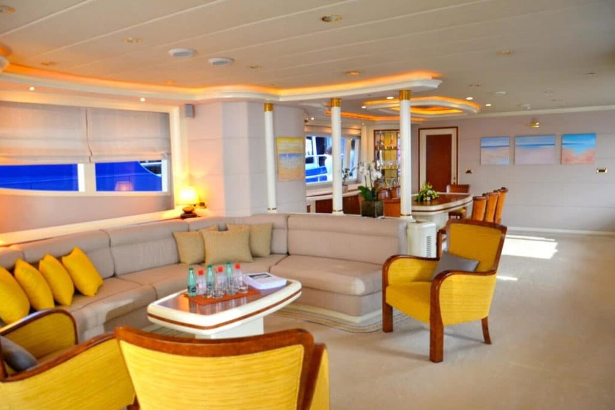 A living room with a couch and yellow chairs