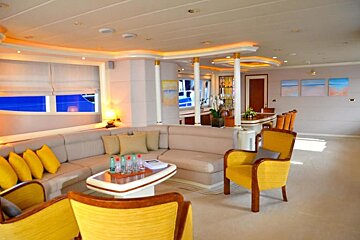 A living room with a couch and yellow chairs