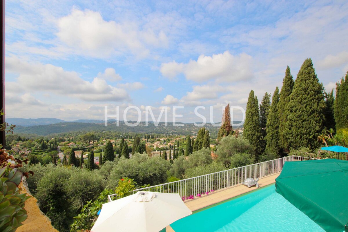 A swimming pool surrounded by trees and a sign that says home sud