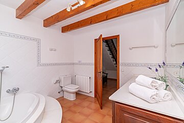 A bathroom with a toilet a sink and a bathtub