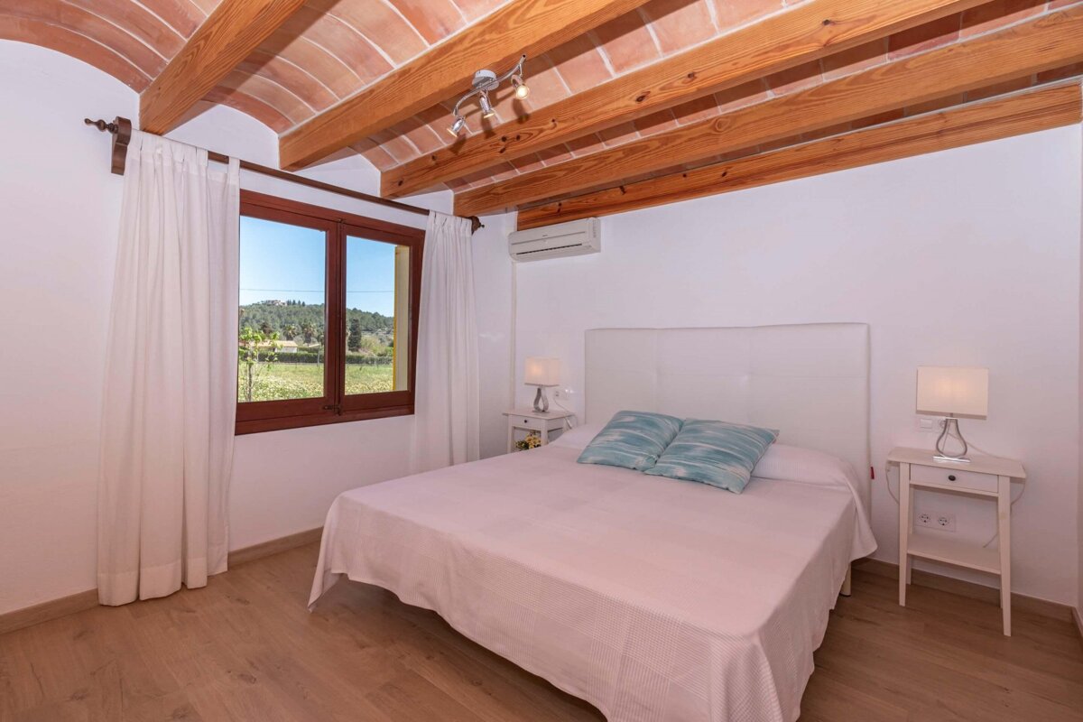 A bedroom with a large bed and two nightstands