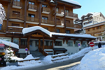 A snowy building with a sign that says sport 2000