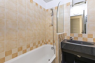 A bathroom with a bathtub and a sink