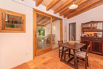 A table and chairs in a room with a sliding glass door