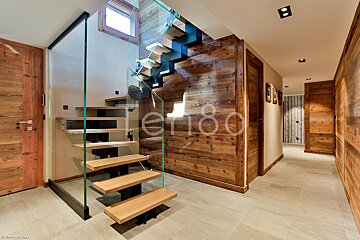 A hallway with a staircase and the number 80 on the wall