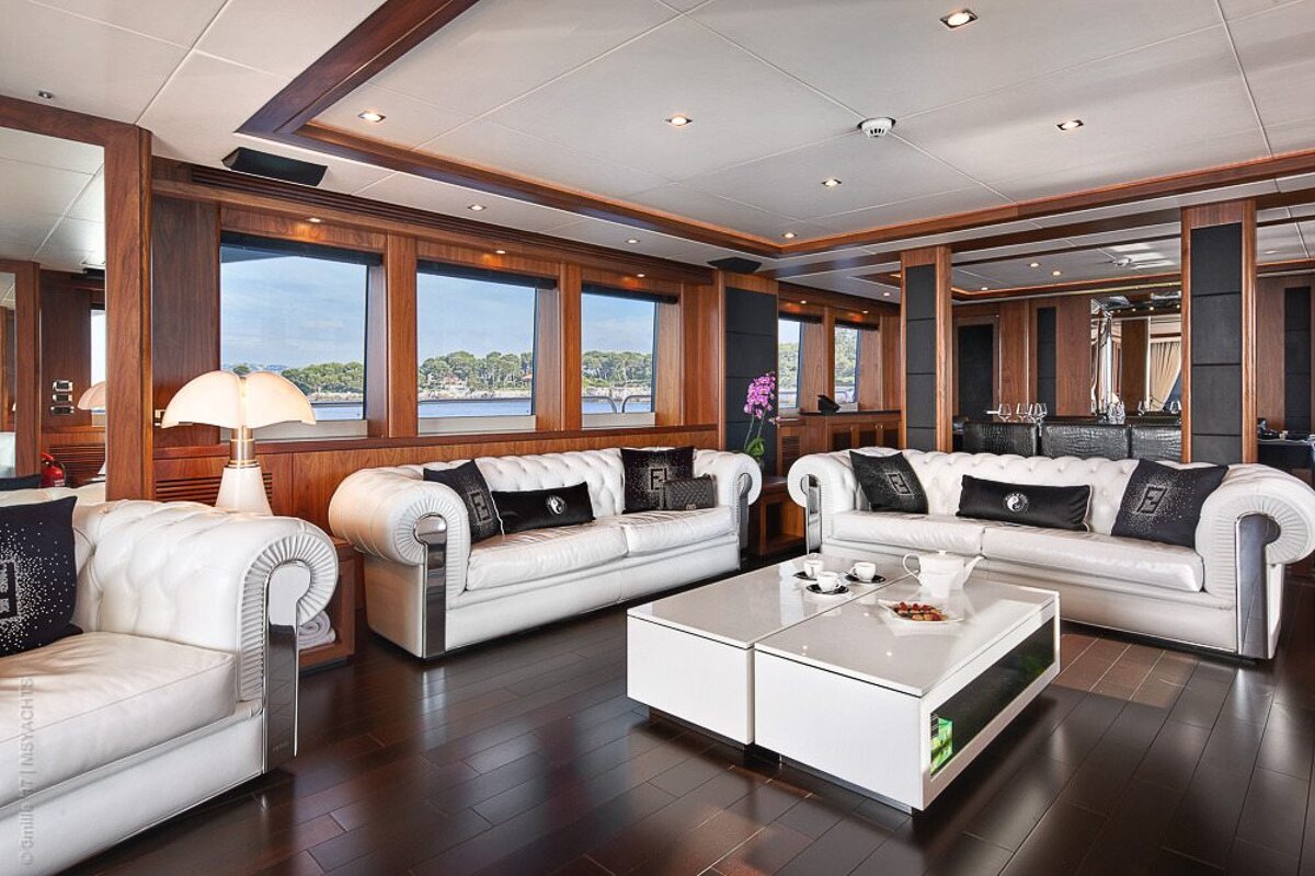 A living room with two white couches and a white coffee table