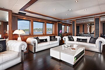 A living room with two white couches and a white coffee table