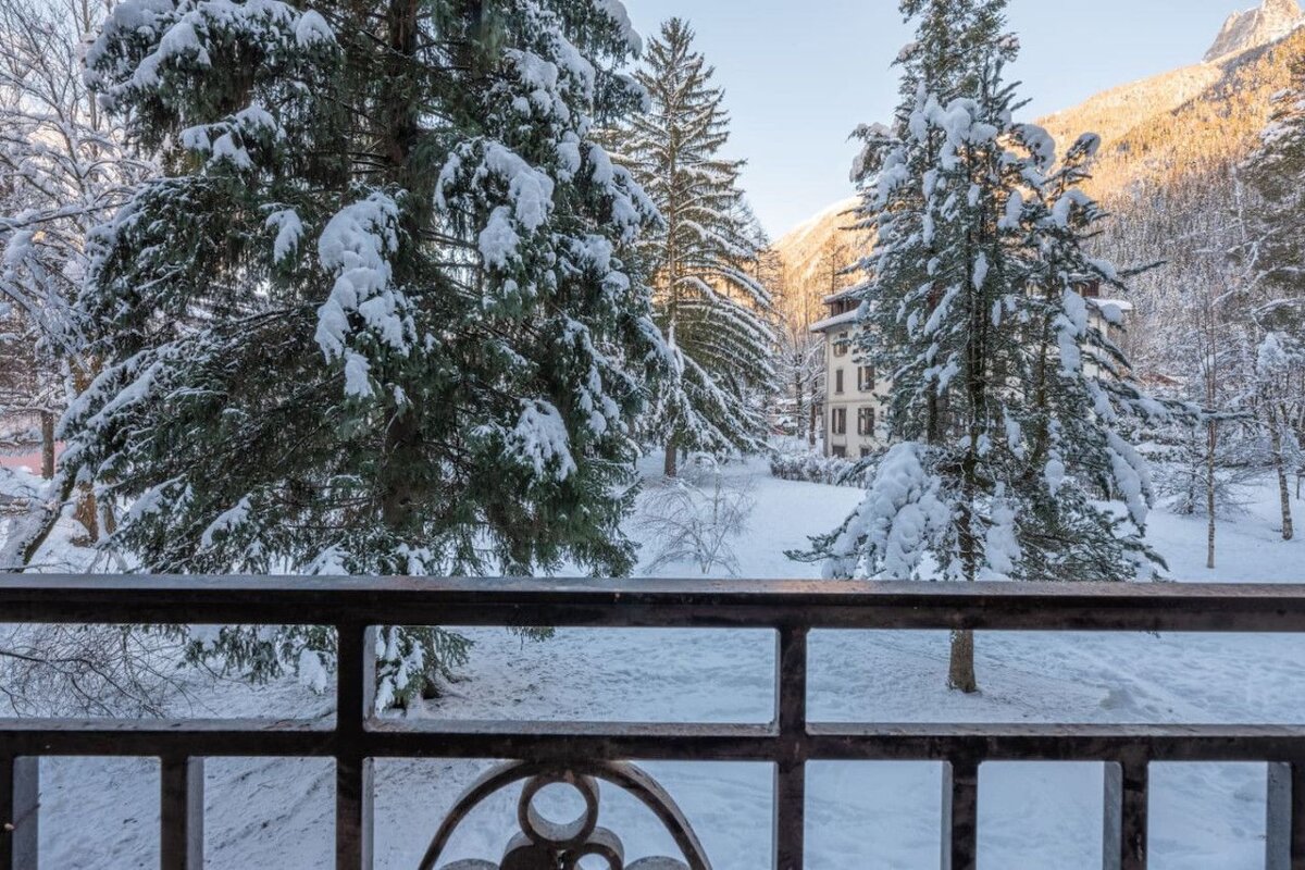 A view of snow covered trees from a balcony