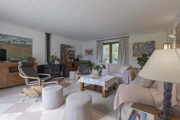 A living room with a couch a chair and a lamp