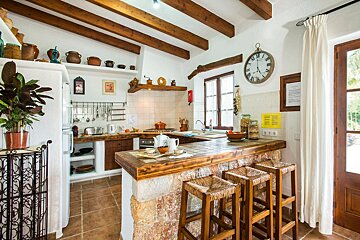 A kitchen with a clock on the wall that says 10:08
