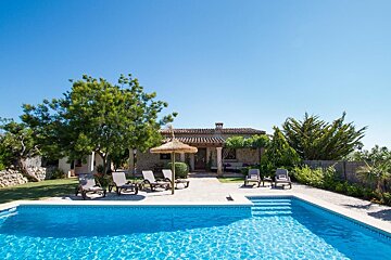 A house with a swimming pool in front of it