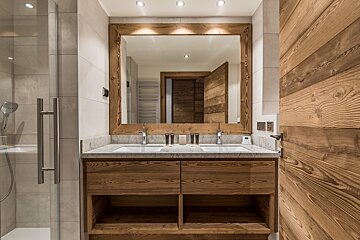 A bathroom with two sinks and a large mirror