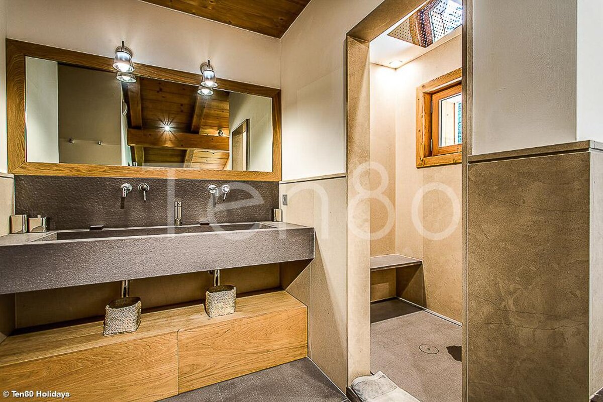 A bathroom with two sinks and a mirror with the number 180 on the wall