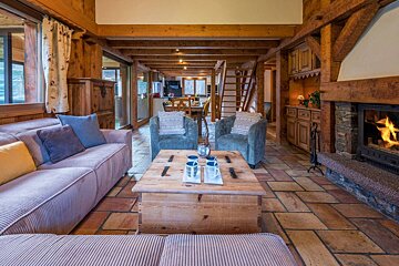 A living room with a couch and chairs and a fireplace