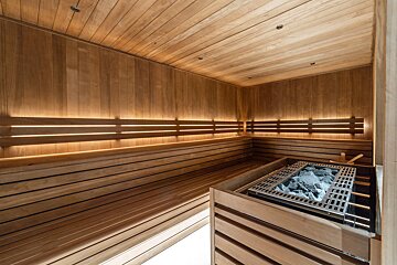 A room with a lot of shelves and a bench with a helmet on it