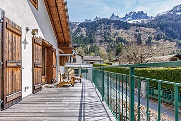 A balcony with a view of a mountain range