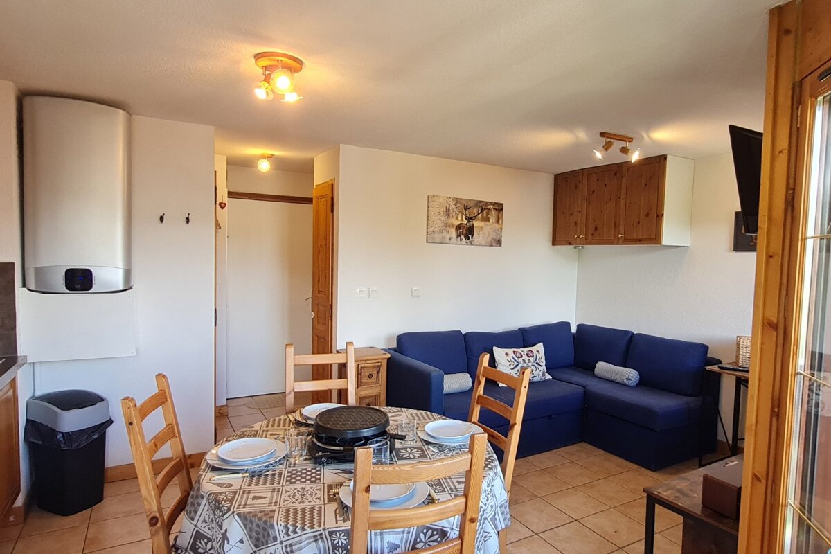 A living room with a couch a table and chairs