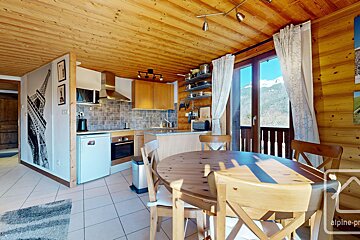 A kitchen with a table and chairs and a sign that says alpine-pro