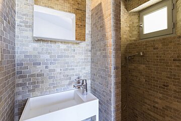A bathroom with a sink a mirror and a window