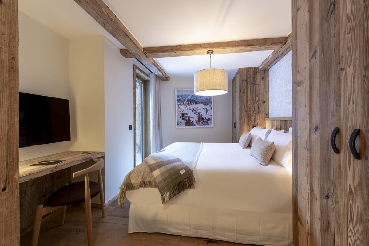 A bedroom with a large bed and a television