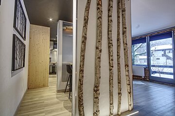 A hallway with a few sticks on the wall