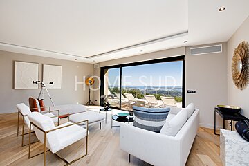 A living room with a couch and chairs and a sign that says home sud