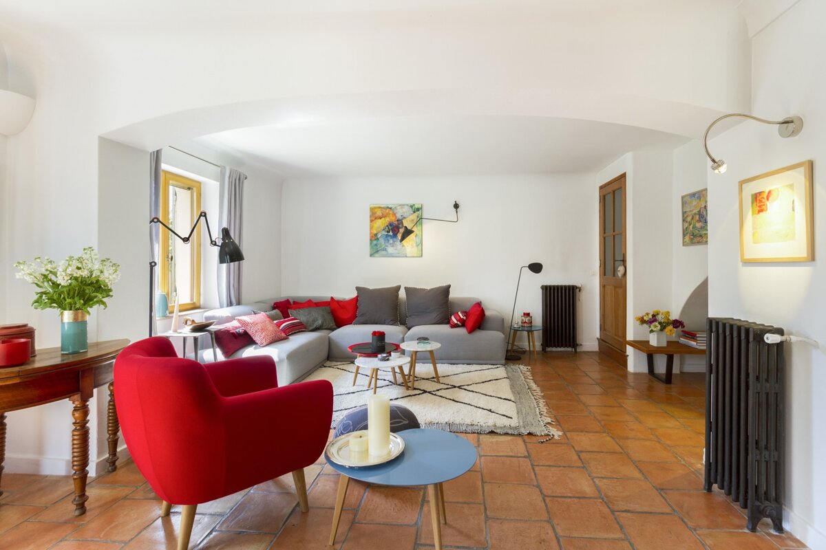 A living room with red chairs and a couch