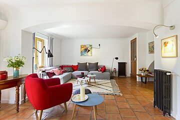 A living room with red chairs and a couch