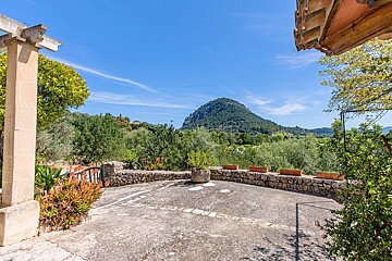 A stone wall with a mountain in the background