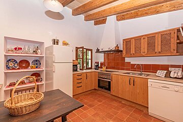 A kitchen with wooden cabinets and a white refrigerator