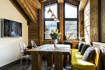 A wooden table with a vase of flowers on it