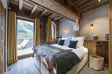 A bedroom with a large bed and a book on the wall that says ' abercrombie & fitch '