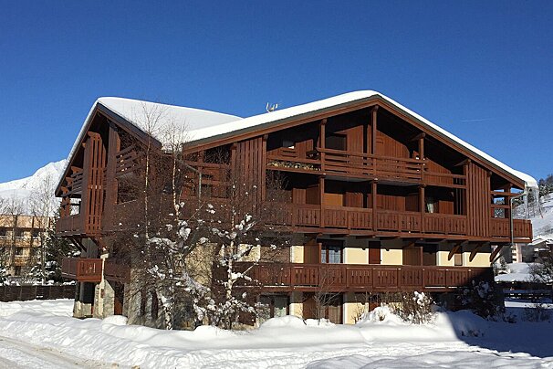 A snowy building with a blue sky in the background