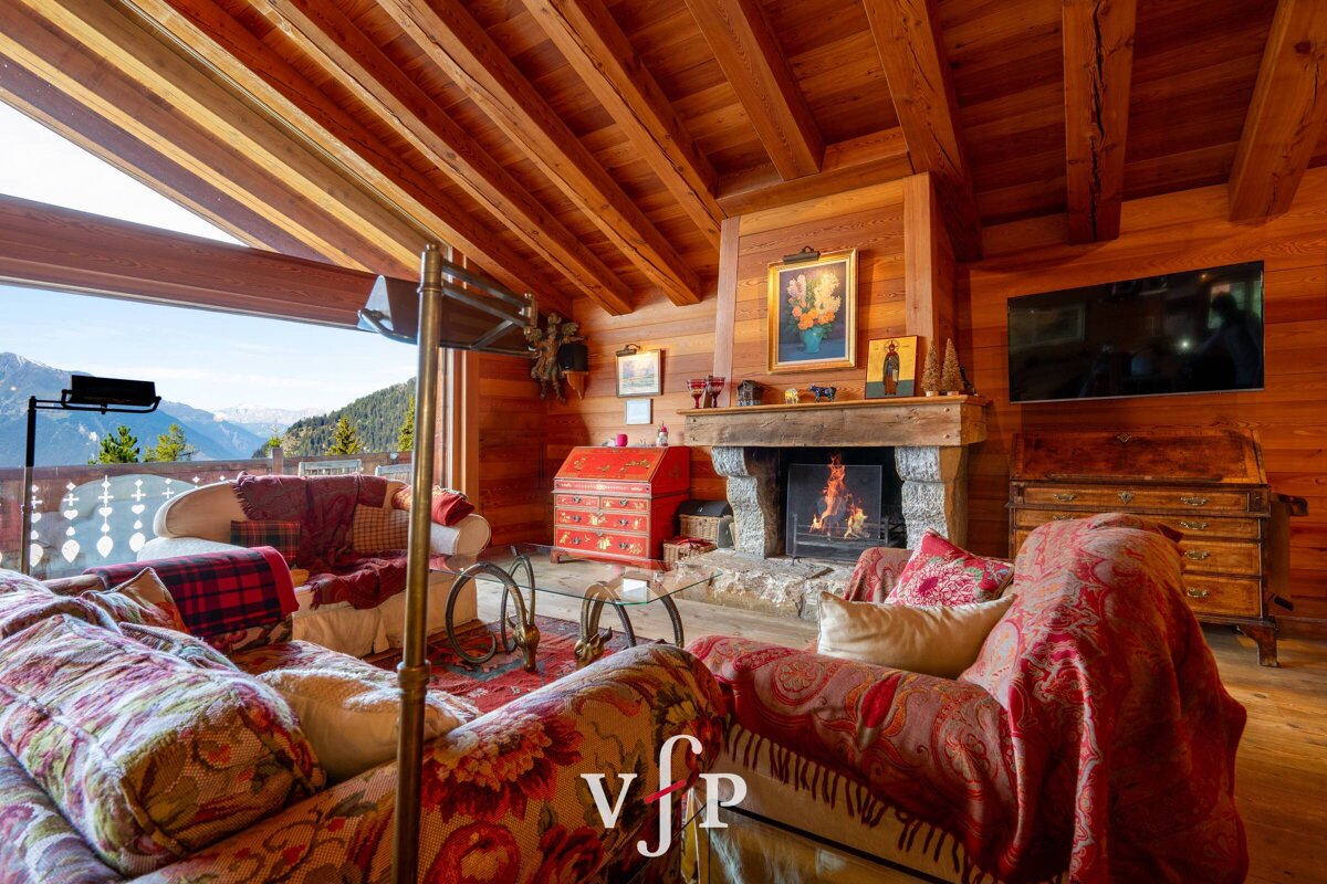 A living room with a fireplace and a couch with the letter v on it