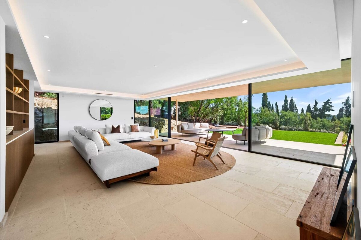 A living room with sliding glass doors leading to a patio