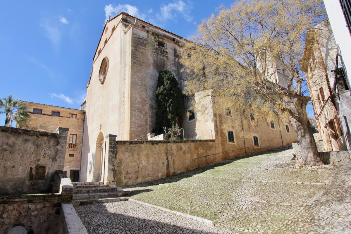 An old building with a tree in front of it