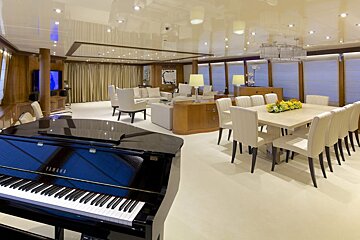 A yamaha piano sits in the middle of a living room