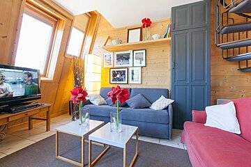 A living room with a couch and a flat screen tv