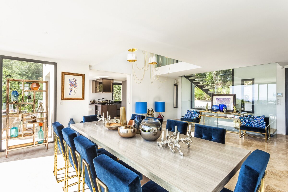 A dining room with a long table and blue chairs