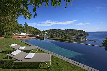 A large swimming pool with a view of the ocean