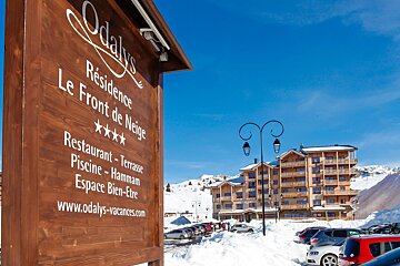 A wooden sign for odalys residence le front de neige