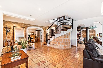A living room with a staircase leading up to the second floor