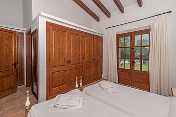 A bedroom with two beds and a large closet
